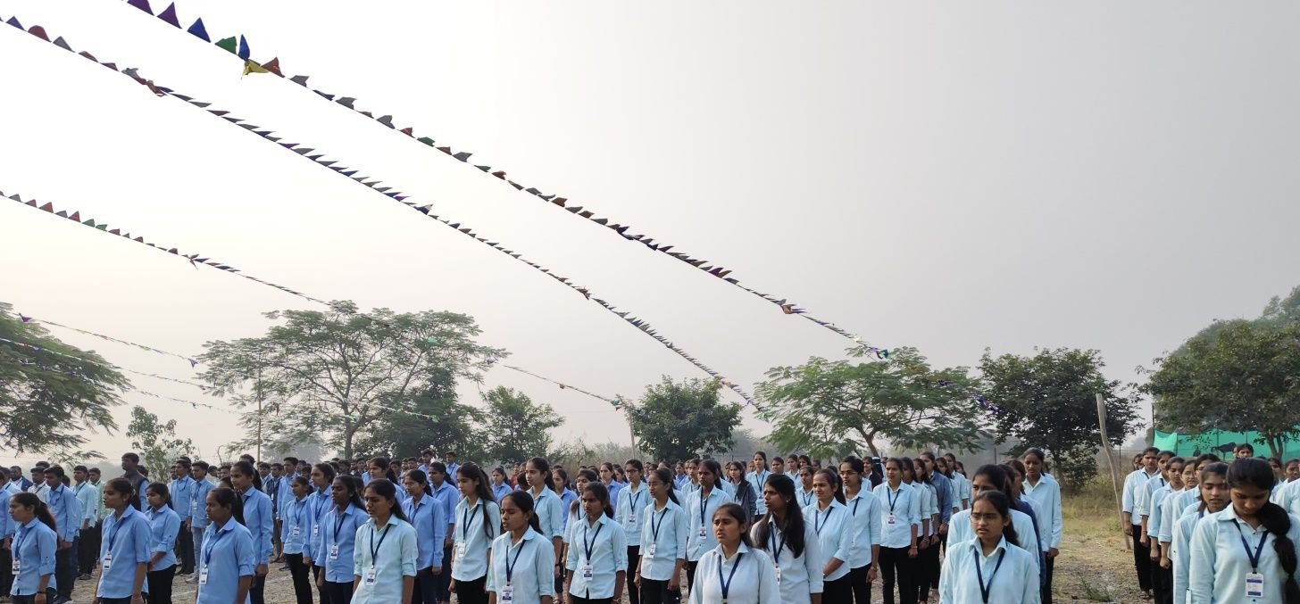 Students standing in rows on the campus ground